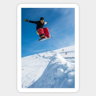 Snowboarder jumping against blue sky Sticker